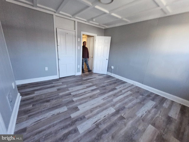 unfurnished bedroom with dark wood-type flooring