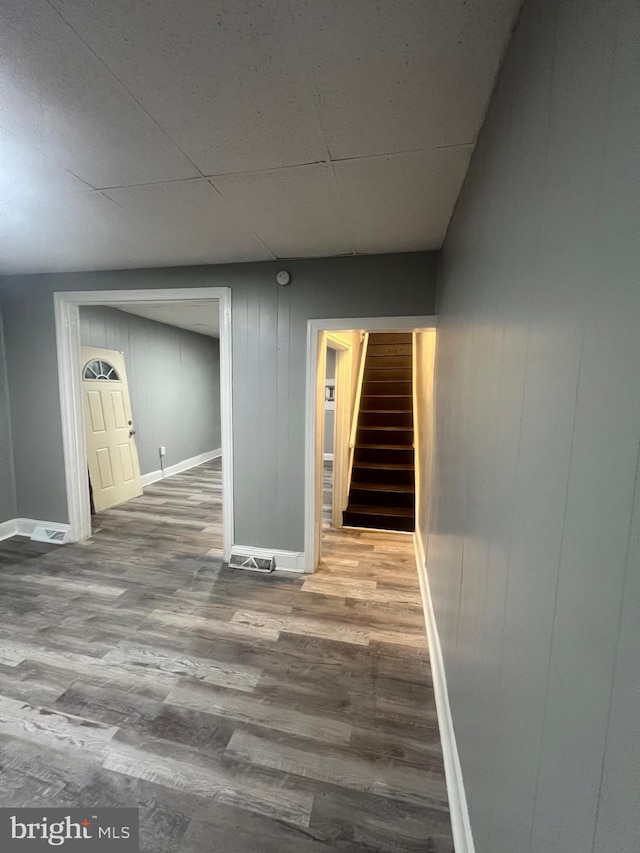 interior space featuring hardwood / wood-style floors and wood walls