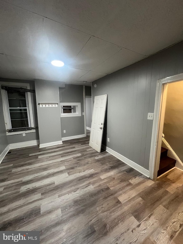 interior space with wood-type flooring and wood walls