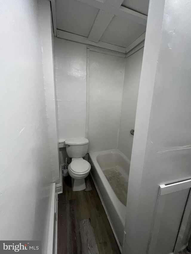 bathroom featuring a shower, wood-type flooring, and toilet