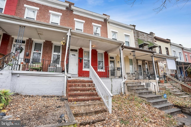 2348 Sidney Ave, Baltimore, MD 21230 - view of property with a porch, brick siding, and stairway