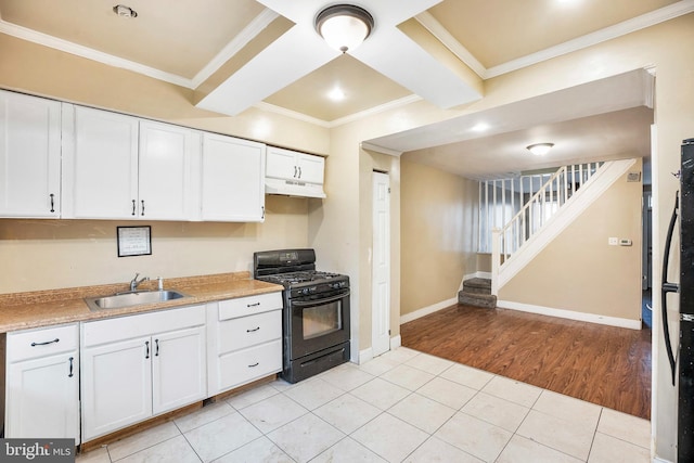 kitchen with light tile patterned flooring, sink, ornamental molding, gas stove, and white cabinetry