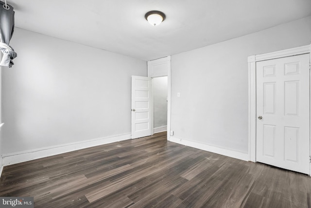 unfurnished room featuring dark hardwood / wood-style flooring