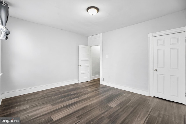 2348 Sidney Ave, Baltimore, MD 21230 - unfurnished bedroom featuring dark wood-style flooring and baseboards