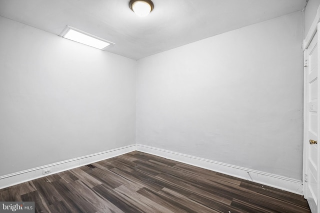 unfurnished room featuring dark hardwood / wood-style flooring