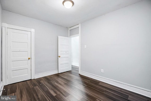 unfurnished bedroom with dark hardwood / wood-style floors