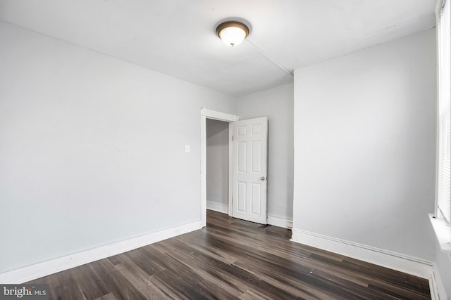 empty room with dark hardwood / wood-style floors