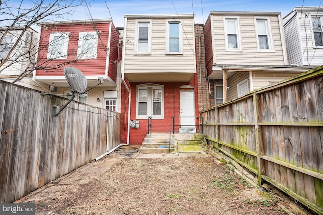 2348 Sidney Ave, Baltimore, MD 21230 - back of house featuring brick siding and a fenced backyard