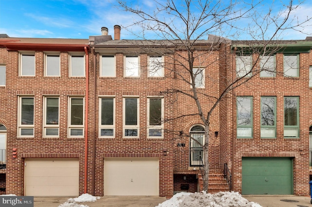 multi unit property featuring a garage