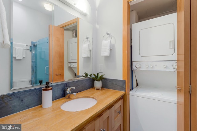 bathroom with vanity and stacked washing maching and dryer