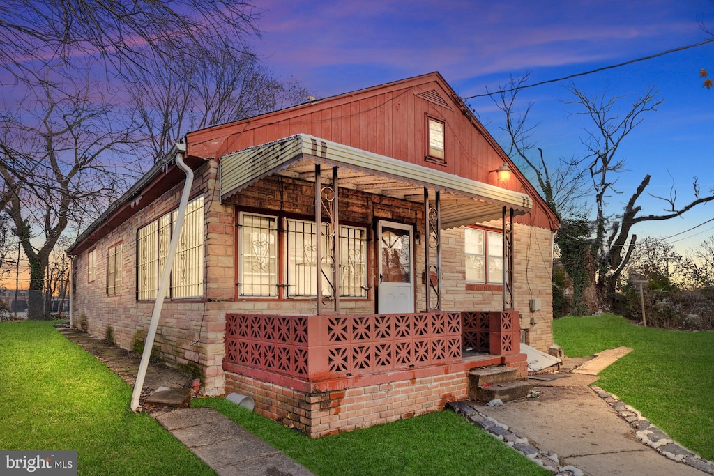 view of front of property with a yard and a porch