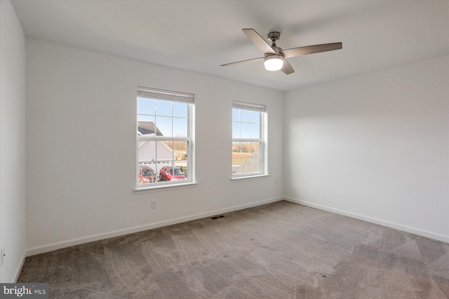 carpeted empty room featuring ceiling fan