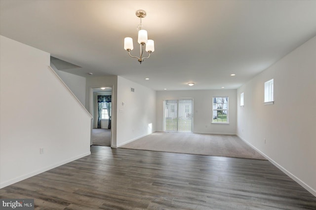 unfurnished room featuring dark hardwood / wood-style flooring and a chandelier