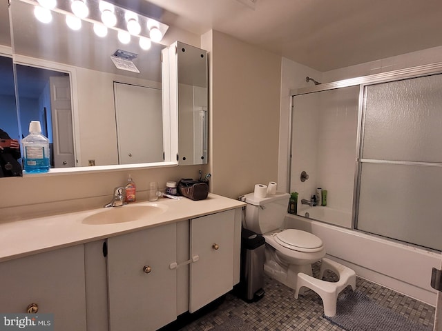 full bathroom with toilet, vanity, tile patterned flooring, and combined bath / shower with glass door