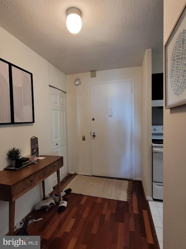 entryway featuring wood-type flooring and a textured ceiling