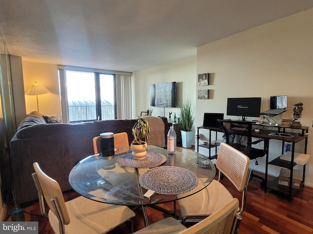 dining area featuring dark wood-type flooring