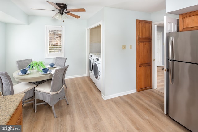 dining area featuring ceiling fan, light wood-type flooring, and washing machine and clothes dryer