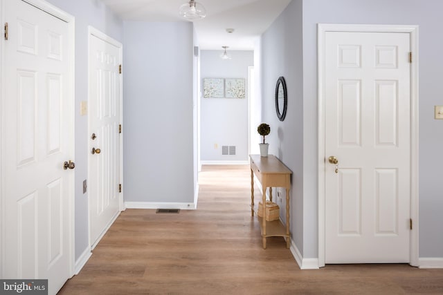 hallway with light wood-type flooring