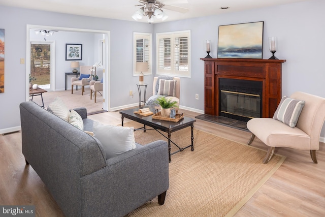 living room with ceiling fan and light hardwood / wood-style flooring