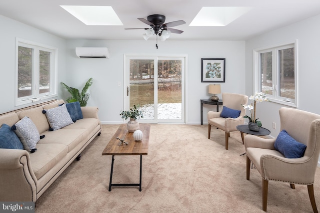 carpeted living room with ceiling fan, a skylight, and a wall unit AC