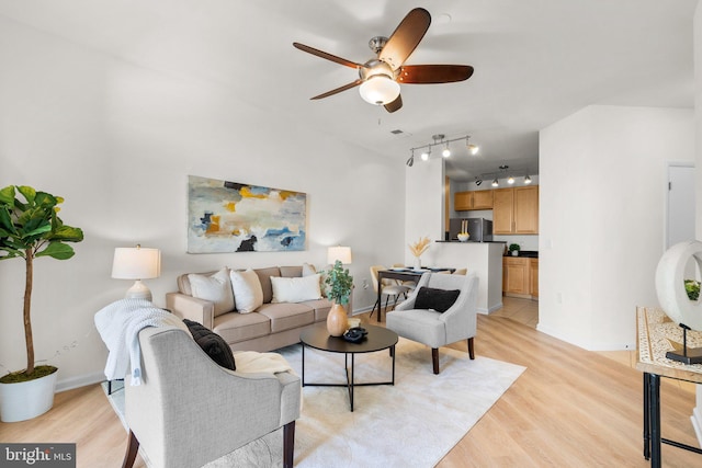 living room with ceiling fan and light hardwood / wood-style floors