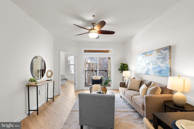 living room featuring ceiling fan and light wood-type flooring