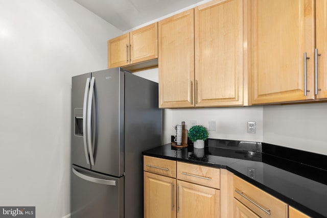 kitchen featuring stainless steel refrigerator with ice dispenser and light brown cabinets