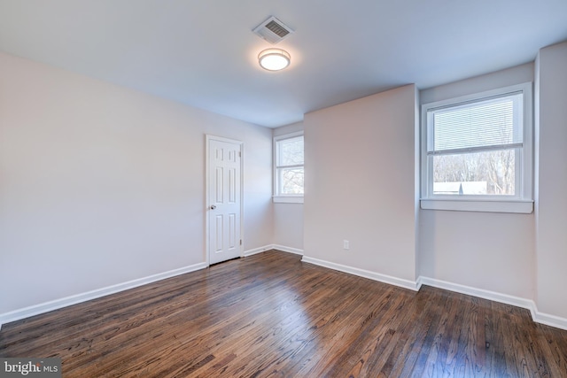 spare room with dark hardwood / wood-style flooring