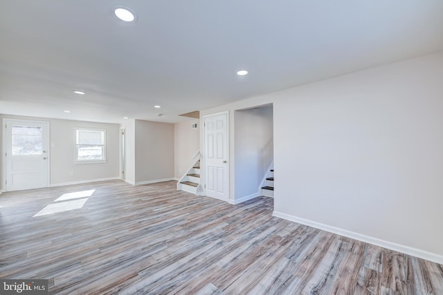 basement with light hardwood / wood-style flooring