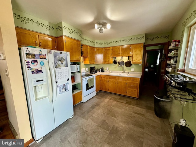 kitchen featuring sink and white appliances