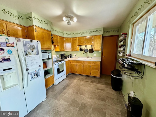 kitchen featuring sink and white appliances