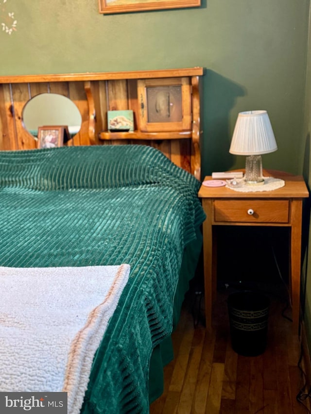 bedroom with dark hardwood / wood-style flooring