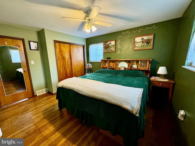 bedroom featuring ceiling fan, hardwood / wood-style flooring, and a closet