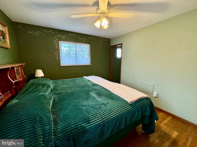 bedroom with ceiling fan and hardwood / wood-style floors