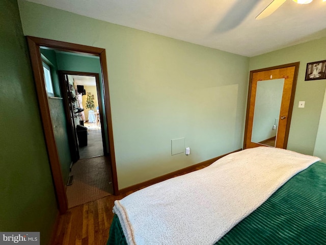 bedroom with ceiling fan and dark hardwood / wood-style flooring