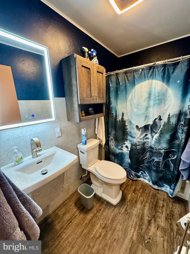 bathroom with toilet, tile walls, sink, hardwood / wood-style flooring, and a shower with shower curtain