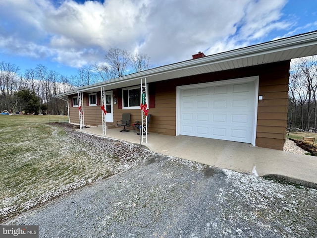 single story home featuring a garage and a front lawn