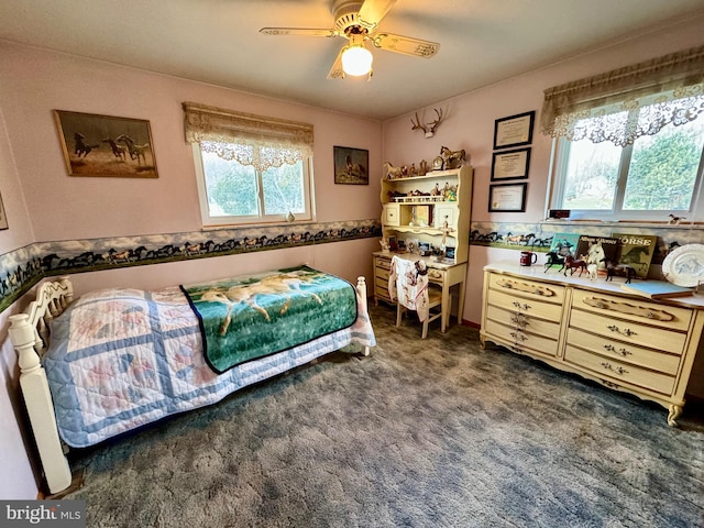 bedroom featuring ceiling fan and dark carpet