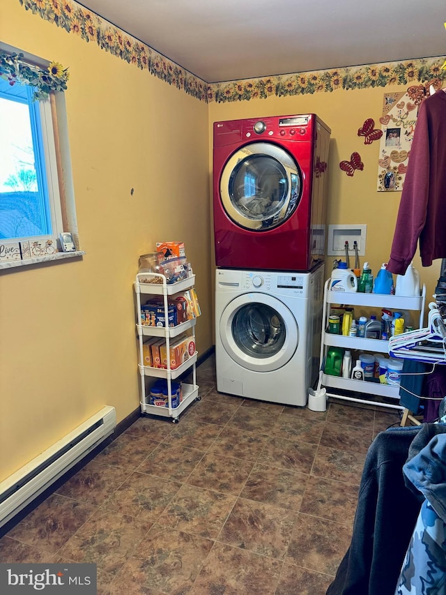 clothes washing area with a baseboard radiator and stacked washer / dryer