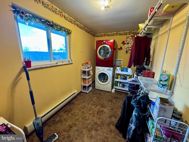 washroom featuring baseboard heating, stacked washer / drying machine, and a water view