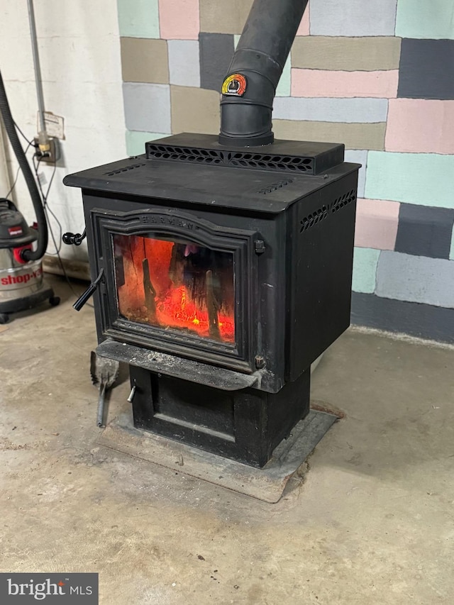 room details featuring a wood stove and concrete flooring