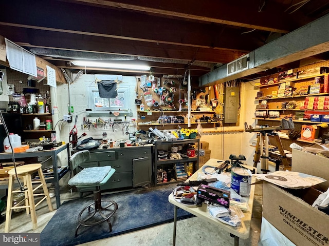 interior space with a workshop area, concrete floors, and electric panel