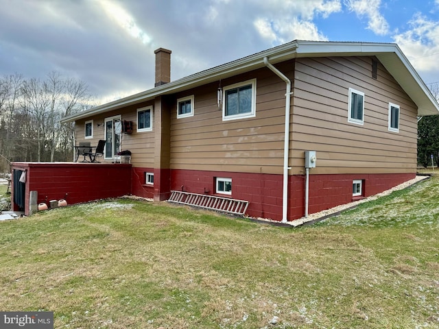 view of home's exterior with a lawn