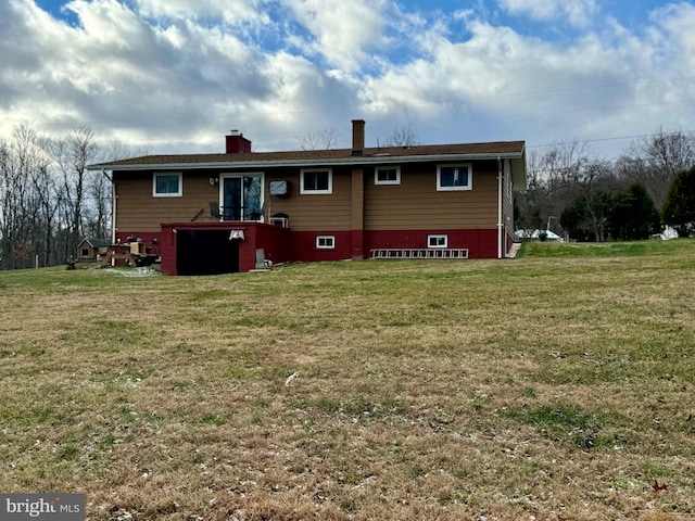 back of property with a lawn