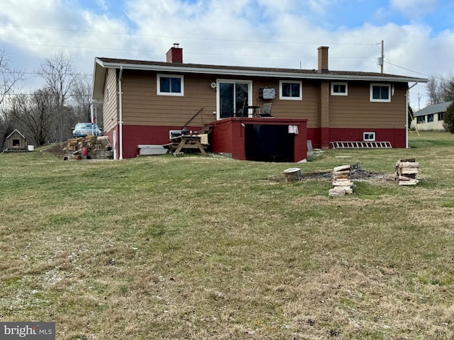 back of house featuring a yard