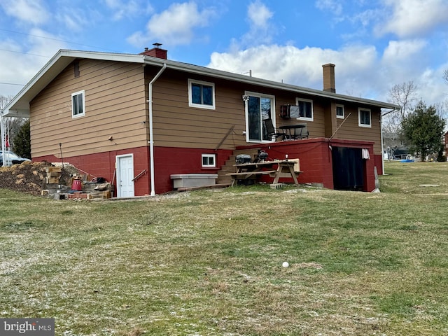 rear view of property featuring a yard