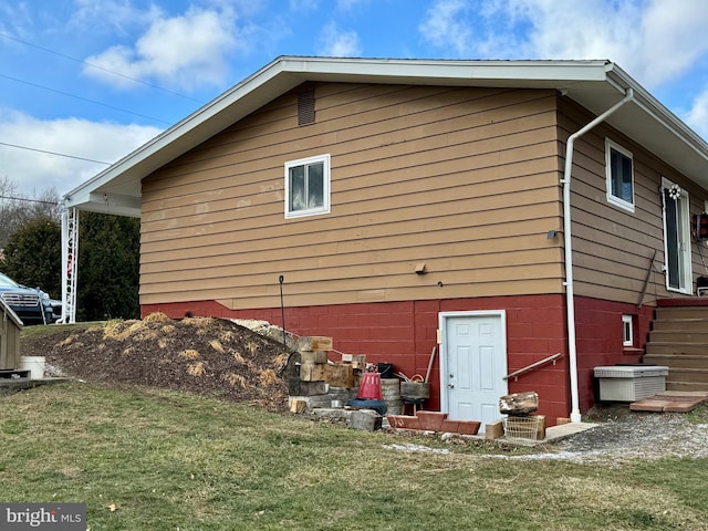 view of property exterior with a lawn