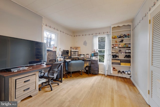 home office with light hardwood / wood-style floors