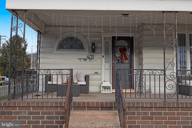 view of exterior entry with a porch