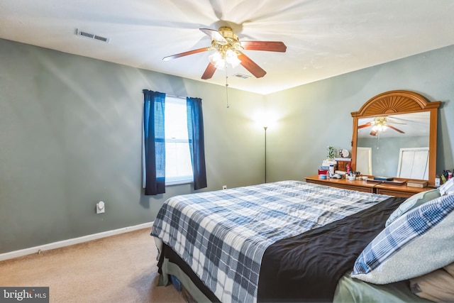 bedroom featuring light carpet and ceiling fan